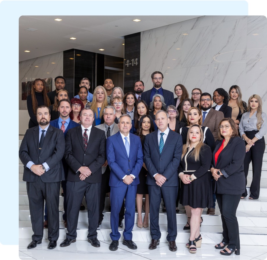 A group of experienced mesothelioma law firm attorneys posing on a staircase