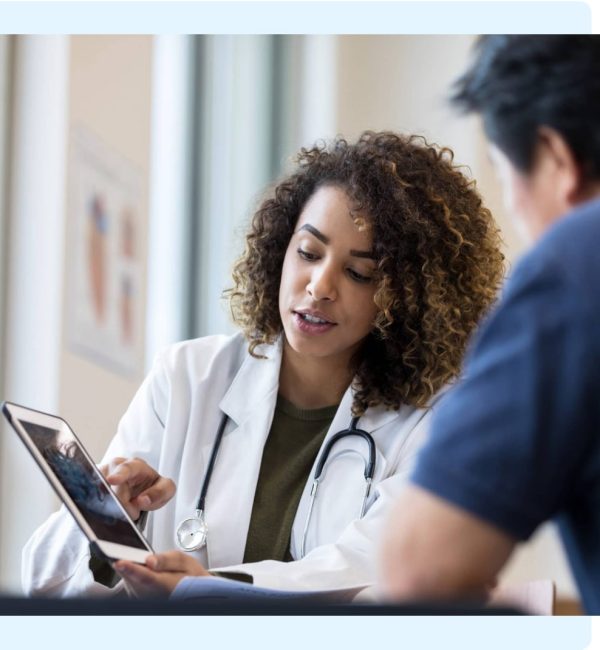 Doctor uses a tablet during a consultation about mesothelioma diagnosis