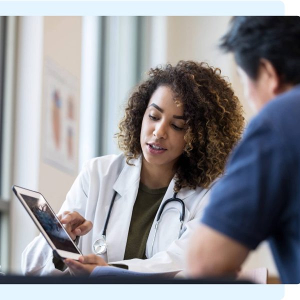 Doctor uses a tablet during a consultation about mesothelioma diagnosis