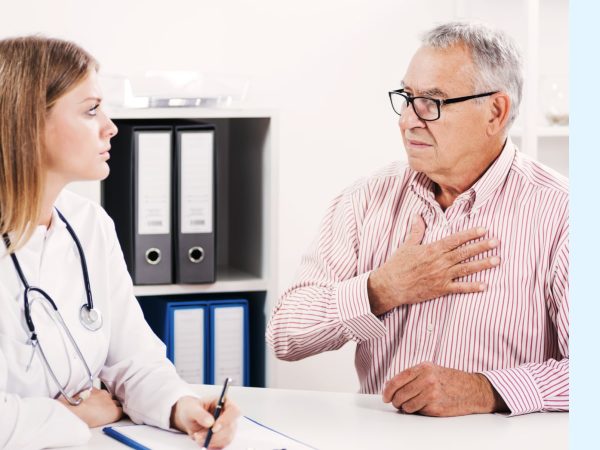 Doctor listens to elderly man’s symptoms as part of a mesothelioma diagnosis process