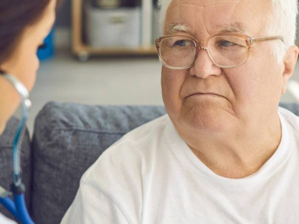 Man's chest examined, showcasing medical and legal assistance from mesothelioma firm.